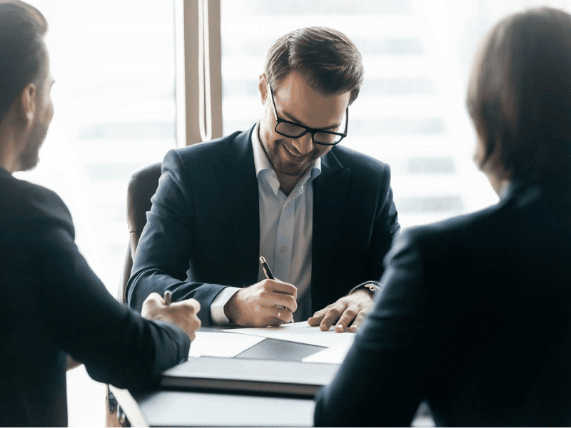 Business owner reviewing legal documents during a company sale